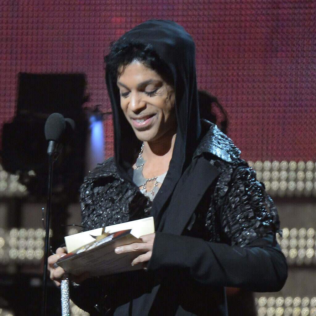 Prince presents an award at the 55th Grammys