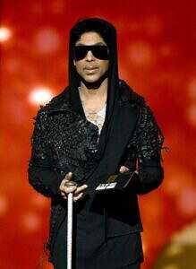 Prince onstage presenting at the 55th Grammys