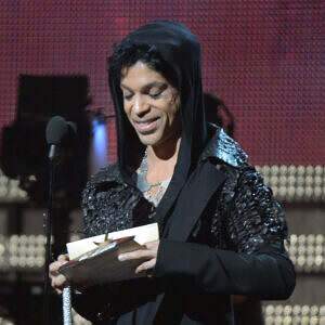 Prince presents an award at the 55th Grammys