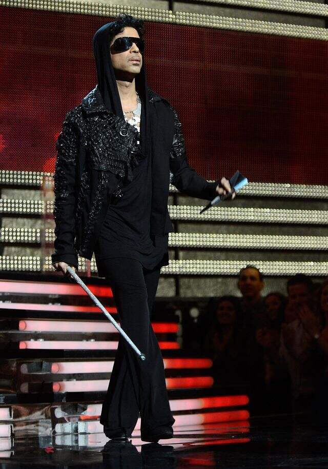 Prince walks to the podium to present "Record of the Year" at the 55th Grammys in 2013