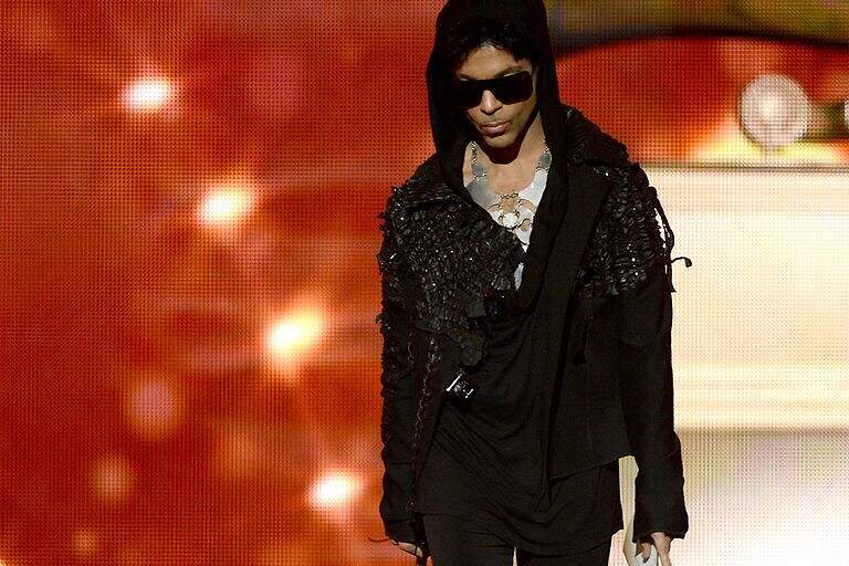Prince walks onstage at The Grammys in 2013