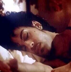 Prince asleep in bed, from the "Purple Rain" movie