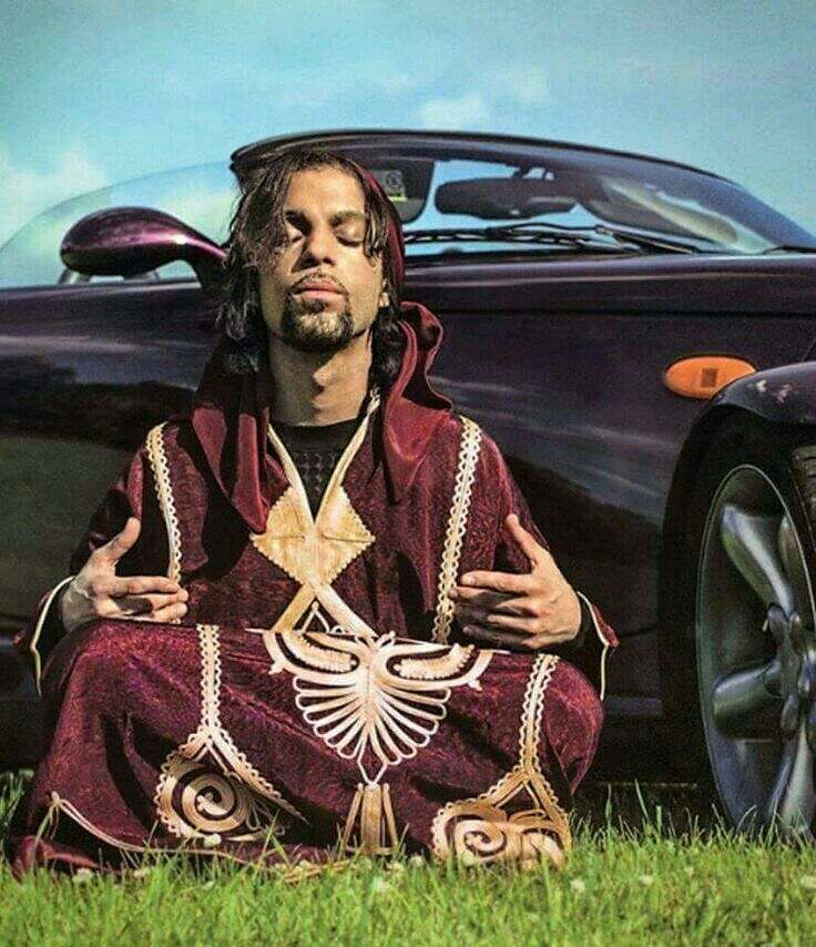 Prince meditating in front of car
