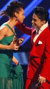 Prince congratulates and presents a Grammy to friend Alicia Keys