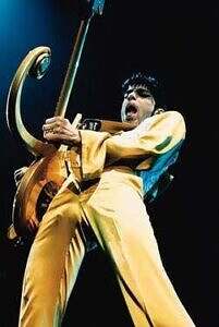 Prince onstage playing love symbol guitar Europe 1995