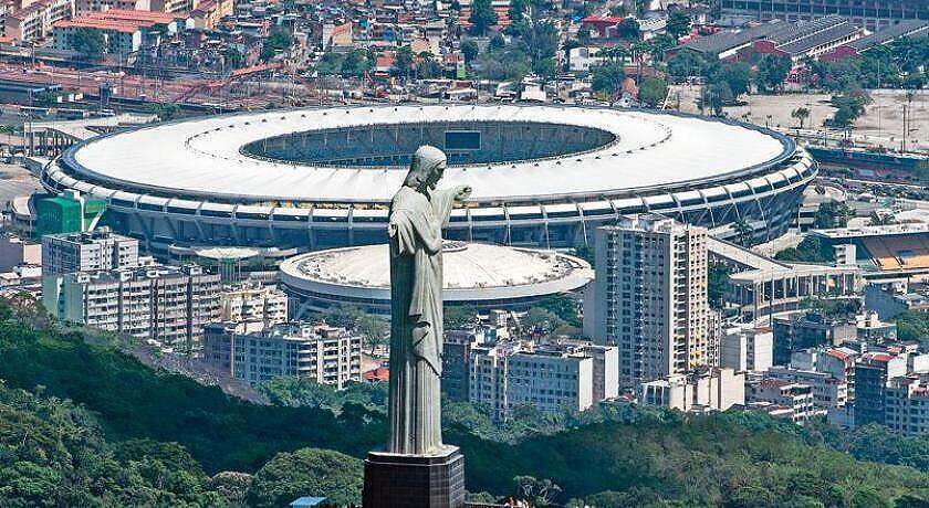 The "Cristo Redentor" statue with Maracana Stadium in its shadow