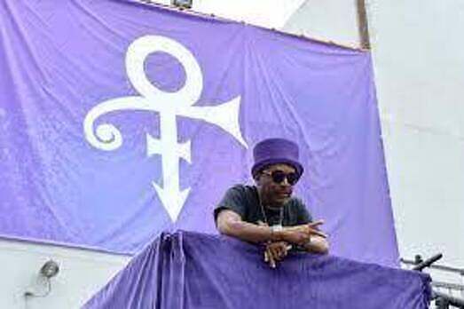 Spike Lee in front of Prince symbol at "Purple Party People 2" in 2017
