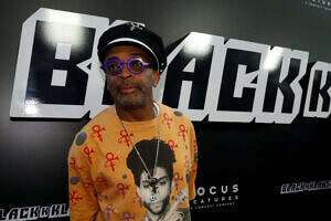 Spike Lee promoting "BlacKKKlansman" with a Prince outfit on