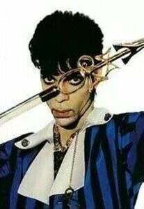 Prince peering through a walking stick in 1994