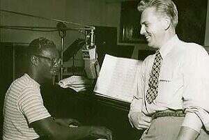 Music Exec James Conkling and Nat King Cole talking in the studio
