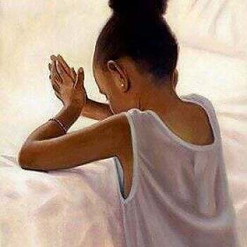 Black child saying prayers